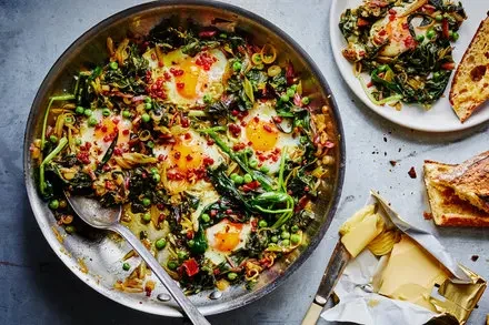 Skillet Greens With Runny Eggs, Peas and Pancetta