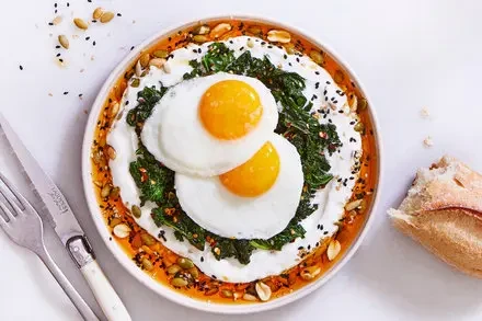 **Spicy Seed-Crusted Egg Brunch Bowl with Yogurt & Wilted Greens**